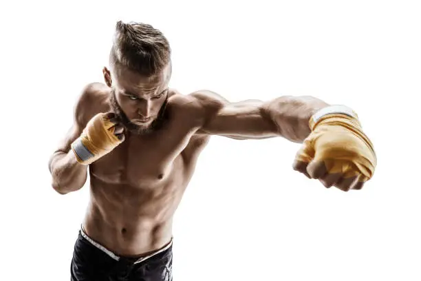 Muscular man throwing a fierce and powerful punch. Photo of sporty man isolated on white background. Strength and motivation