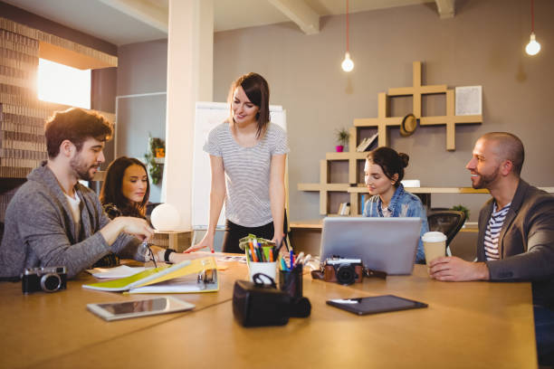 istock Female graphic designer having discussion with coworkers 658657834