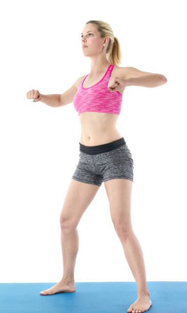 istock Young woman doing full body yoga exercise  on blue mat 658660910