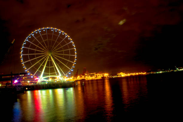 istock Ferris Wheel Over Water at Night 658660920