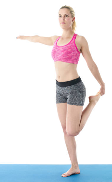 istock Young woman doing full body yoga exercise  on blue mat 658660928