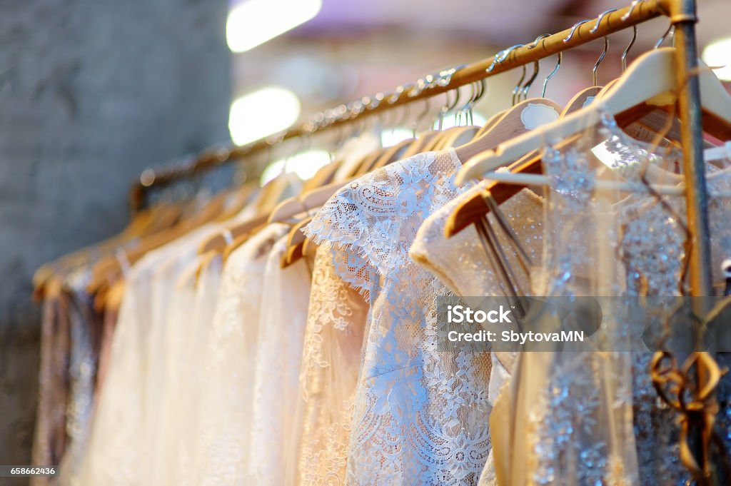 A few beautiful wedding dresses on a hanger. A few beautiful wedding dresses on a hanger. Bridal shop. Dress Stock Photo