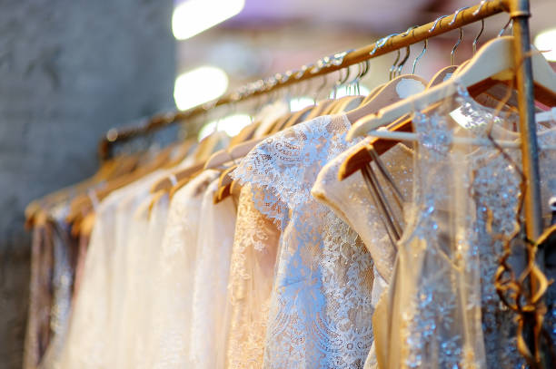 a few beautiful wedding dresses on a hanger. - women bride personal accessory adult imagens e fotografias de stock