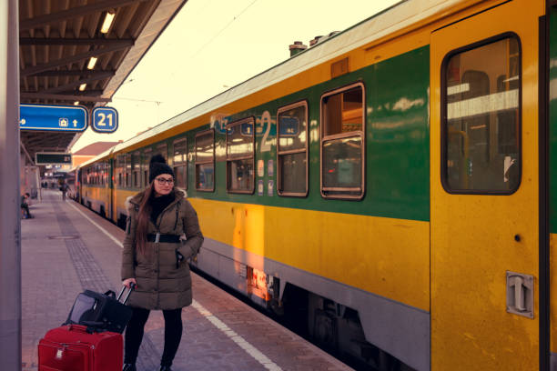 Waiting for the train Young woman waiting for the train - 
 mütze stock pictures, royalty-free photos & images