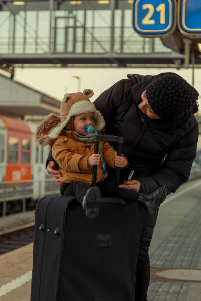 Grandma and grandchild at the train station Waiting for the train mütze stock pictures, royalty-free photos & images