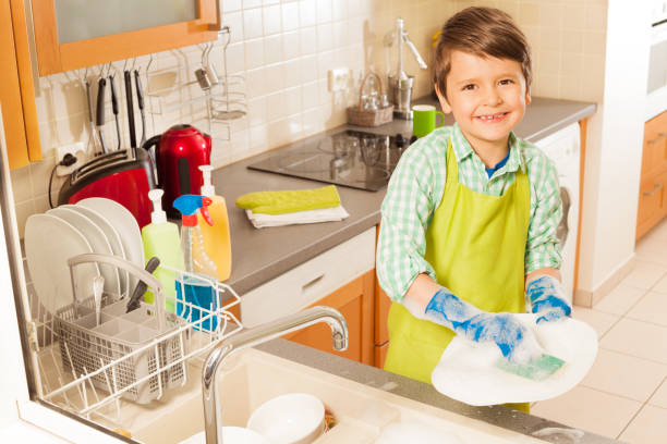 istock Little boy wash dished in sink with mop and soap 658669716