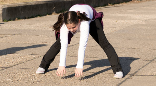 istock Little girl doing exercises in park 658672322