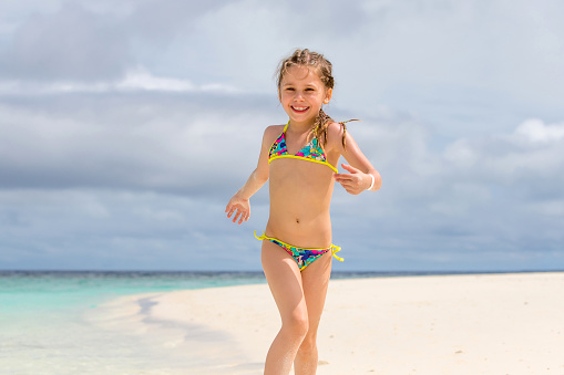 Little Girl Playing On Sandy Beach