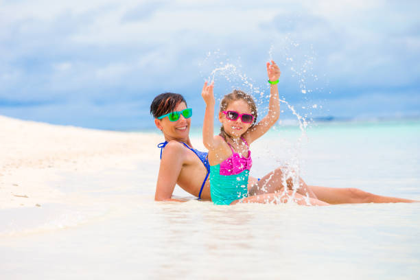 istock Mother And Daugter Sunbathing  On Tropical Beach 658677132