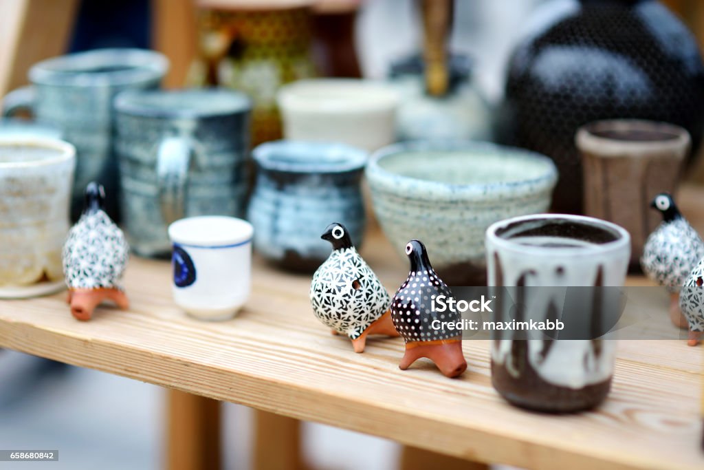 Ceramic dishes, tableware and jugs sold on Easter market in Vilnius, Lithuania Ceramic dishes, tableware and jugs sold on Easter market in Vilnius. Lithuanian capital's annual traditional crafts fair is held every March on Old Town streets. Craft Stock Photo
