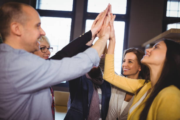 istock Business people high fiving in creative office 658681610