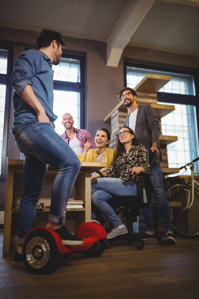 istock Businessman on self-balanced board talking with colleagues 658789802