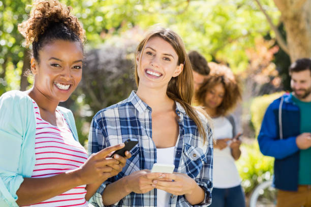 istock Portrait of beautiful women using mobile phone 658803078