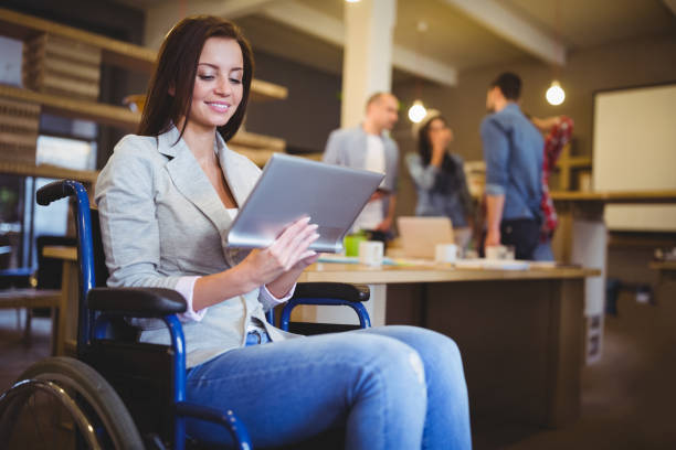 istock Disabled young businesswoman using digital tablet 658803512