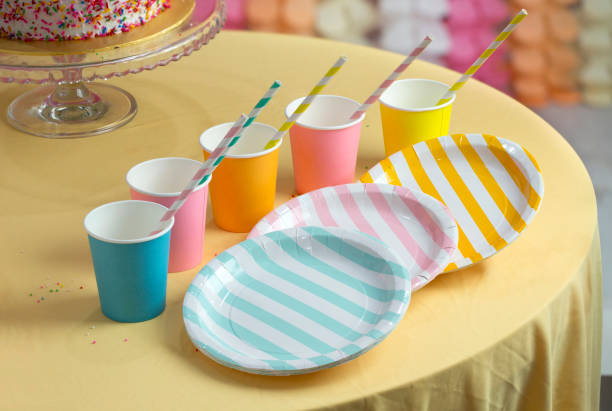 colourful party paper cups and plates on table top. - paper glass imagens e fotografias de stock