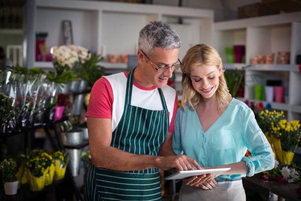 istock Florists using digital tablet in florist shop 658807190
