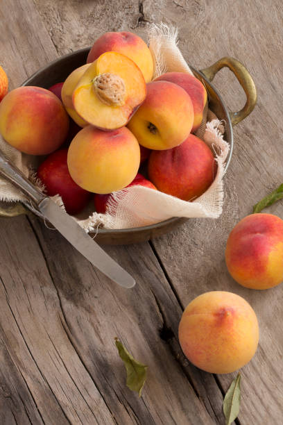 istock Whole peaches on rustic wooden background. 658807252