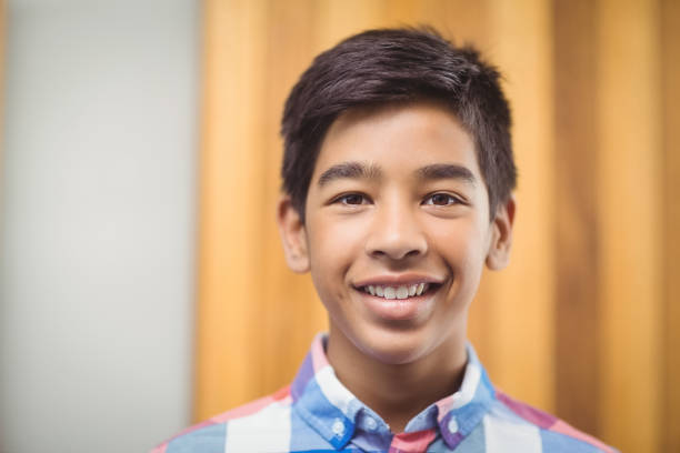istock Portrait of smiling schoolboy 658810724