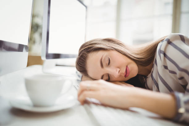 istock Tired businesswoman taking nap in creative office 658814316
