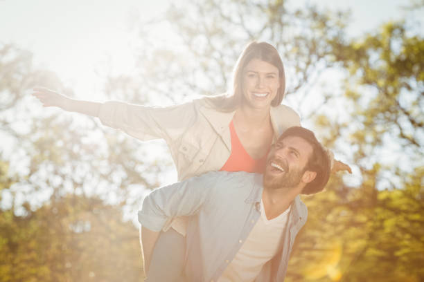 istock Man giving woman piggyback ride 658814842