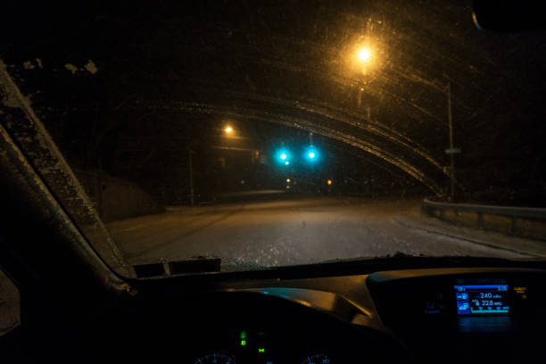 istock Night Car Driver POV Through Frozen Streaked Winter Windshield 658817608