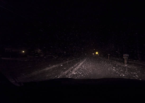 istock Night Car Driver Windshield POV Distracting Blinding Blizzard Snow 658817628