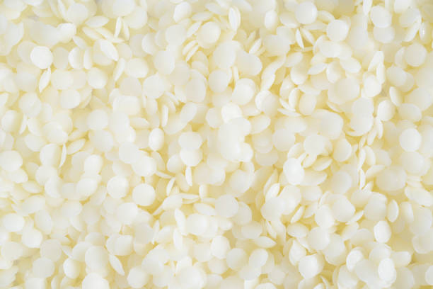 beeswax white cosmetic beeswax pellets background candle wax stock pictures, royalty-free photos & images