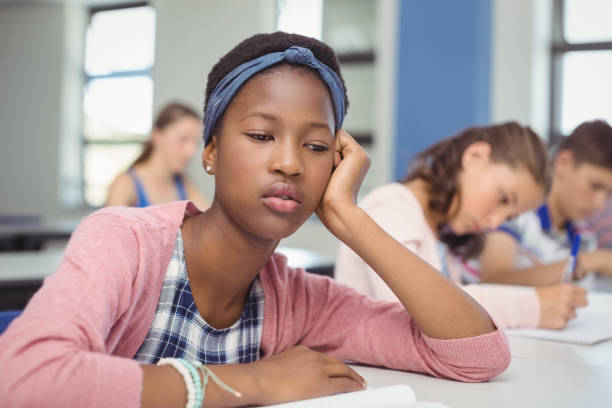 istock Thoughtful schoolgirl sitting in classroom 658821454