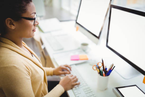 istock High angle view of businesswoman working in creative office 658826936
