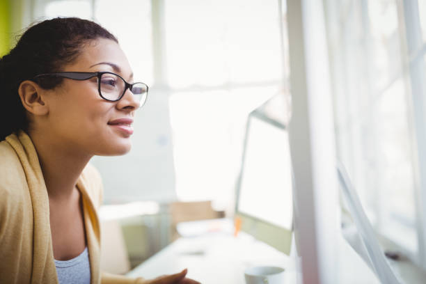 istock Smiling businesswoman working in office 658827068