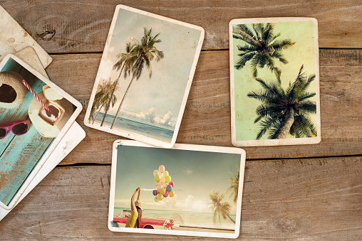 Summer photo album on wood table. instant photo of polaroid camera - vintage and retro style