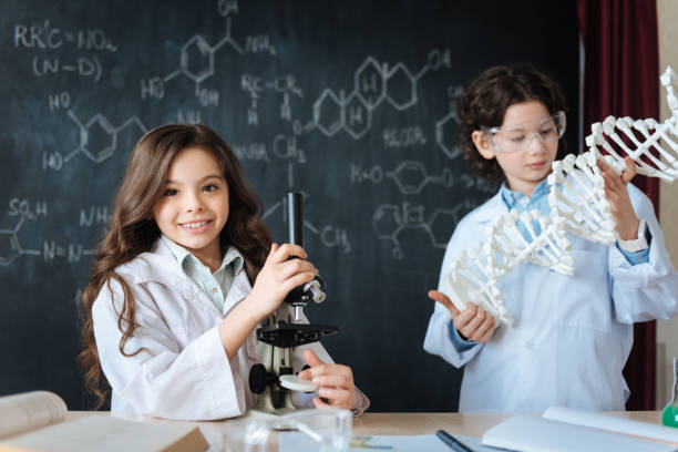 istock Positive little friends studying microbiology at school 658831316