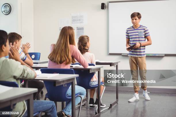 Schoolboy Giving Presentation In Classroom Stock Photo - Download Image Now - Presentation - Speech, Classroom, Teenager