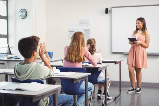 istock Schoolgirl giving presentation in classroom 658835582