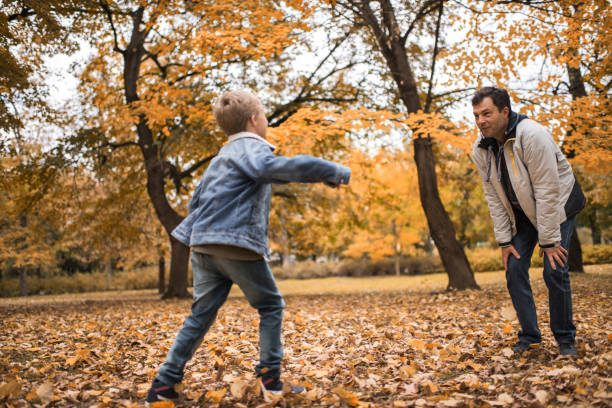 istock Smiling father playing with his son in the park. 658838690