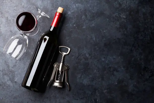 Photo of Red wine glasses and bottle