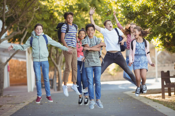 Smiling school kids having fun on road in campus Smiling school kids having fun on road in campus at school secondary school activities stock pictures, royalty-free photos & images
