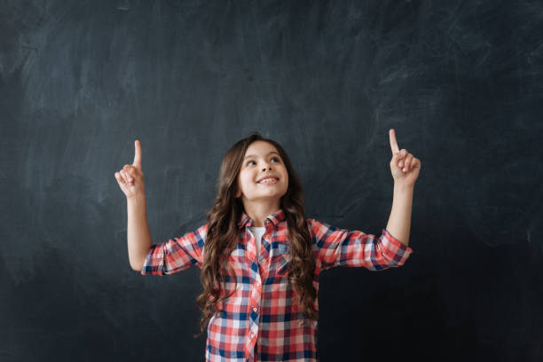 istock Glad girl demonstrating imaginary drawing in the studio 658847354