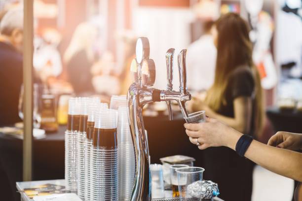 Woman pouring cold beer stock photo