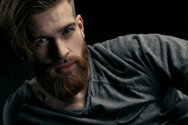 istock portrait of stylish confident man on black 658850620