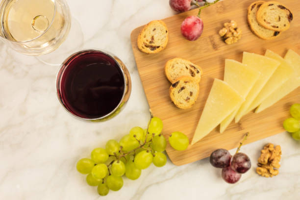 istock White and red wine with cheese, bread and grapes 658854722