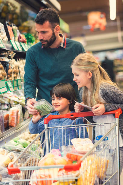 istock Father with son and daughter In A Supermarket. 658861628