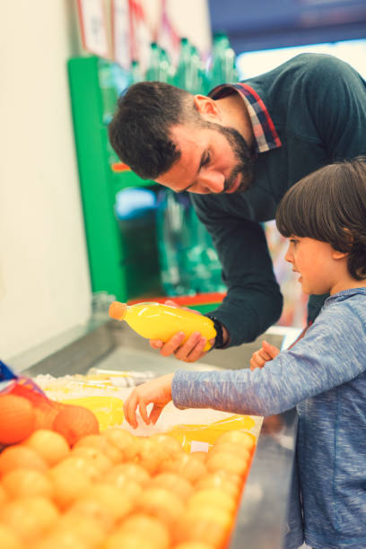 istock Father and Son In A Supermarket. 658861928
