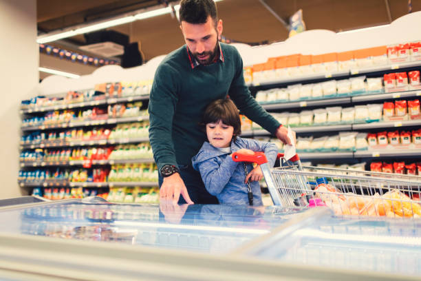 istock Father and Son In A Supermarket. 658862464