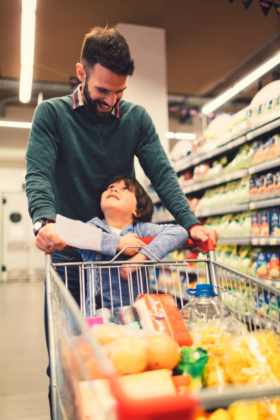 istock Father and Son In A Supermarket. 658862492