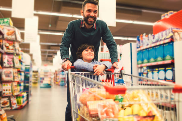 istock Father and Son In A Supermarket. 658862664