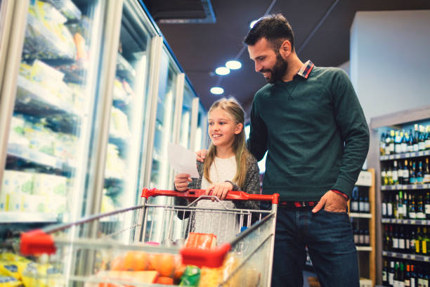 istock Father and Daughter In A Supermarket. 658862956