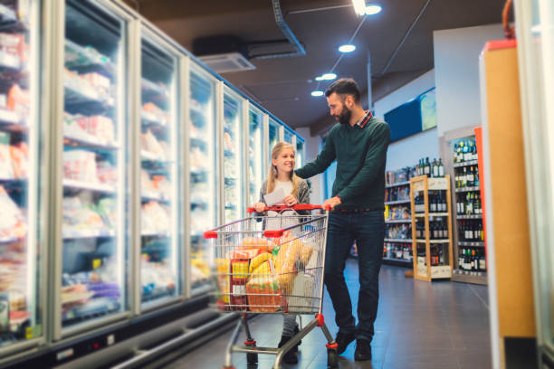 istock Father and Daughter In A Supermarket. 658863364