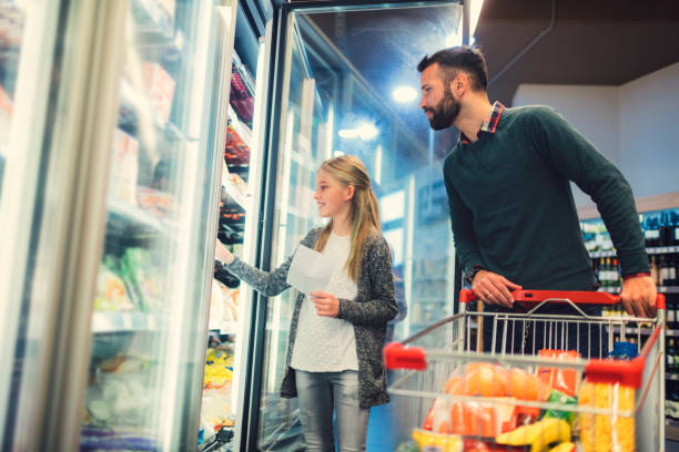 istock Father and Daughter In A Supermarket. 658863456