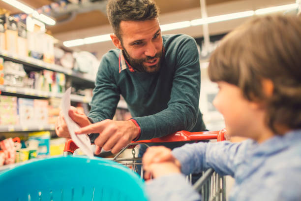 istock Father and Son In A Supermarket. 658864154